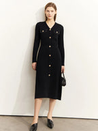 Front view of black ribbed knit midi dress with gold buttons and chest pockets