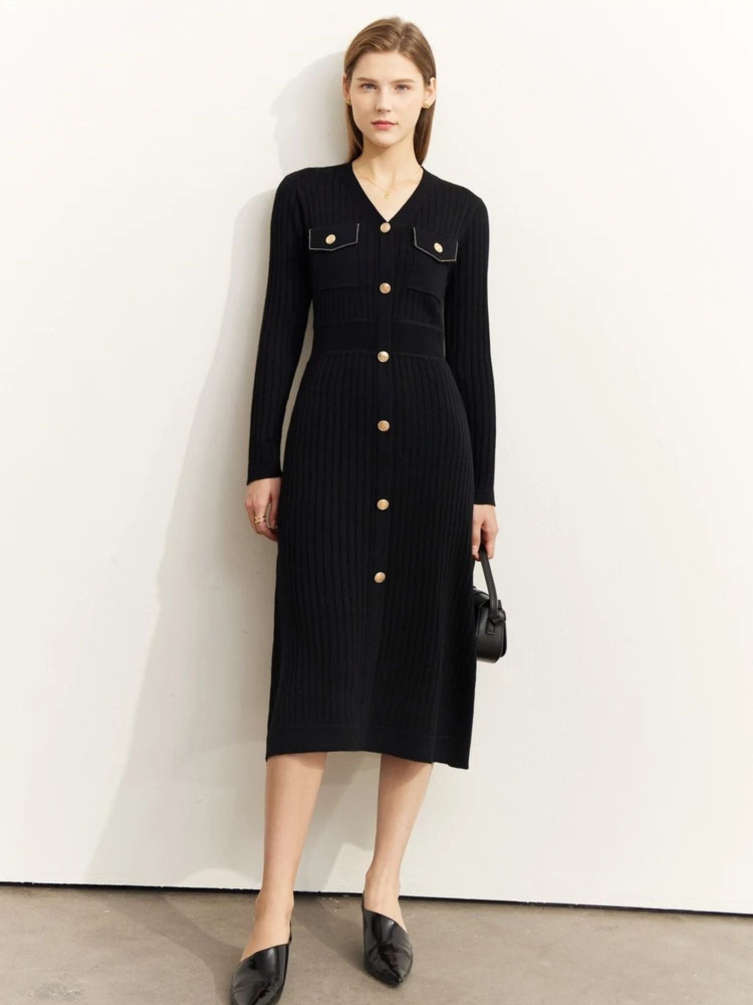 Front view of black ribbed knit midi dress with gold buttons and chest pockets