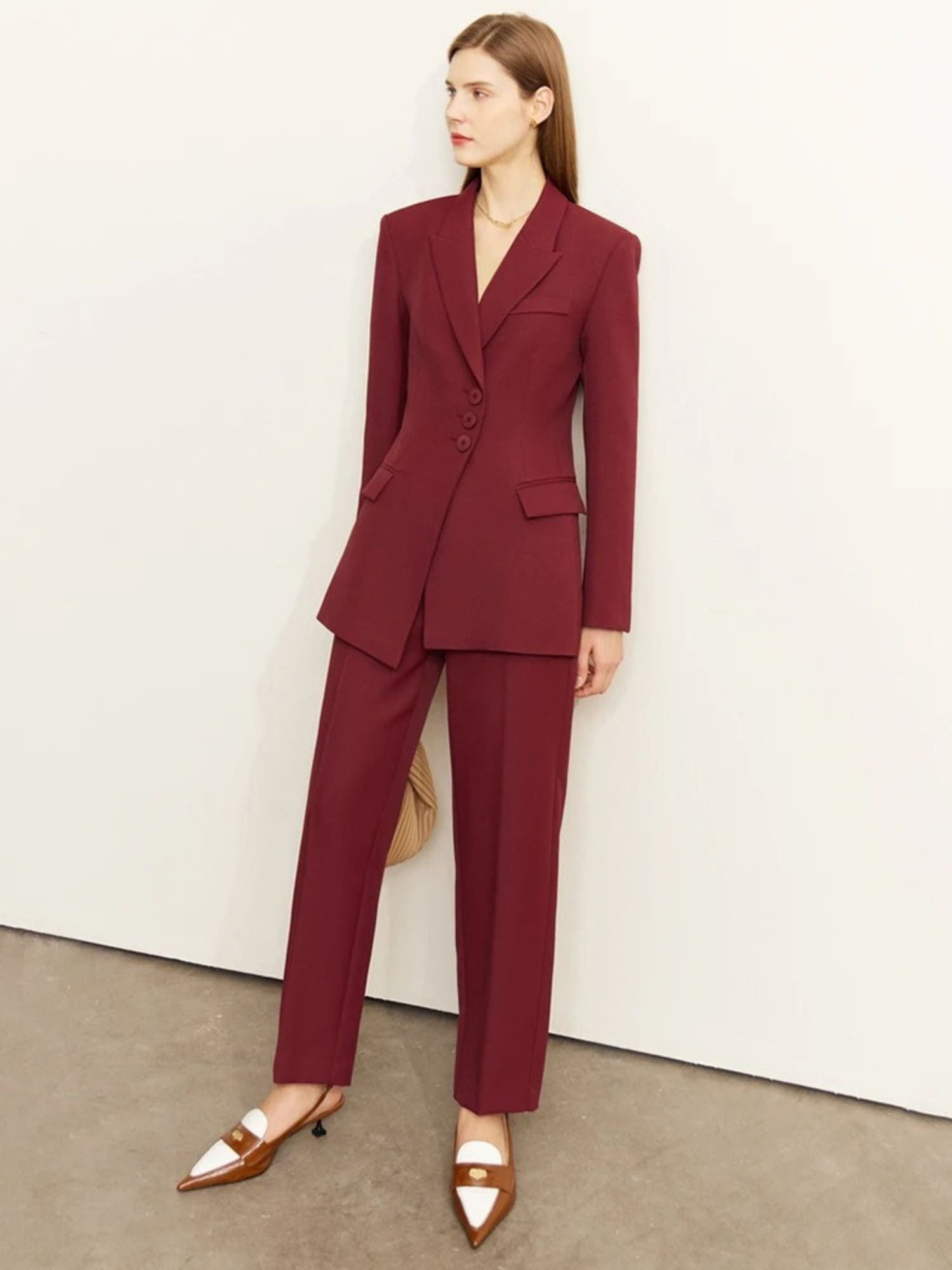 Front view of tailored burgundy pantsuit with double-breasted blazer and straight-leg trousers