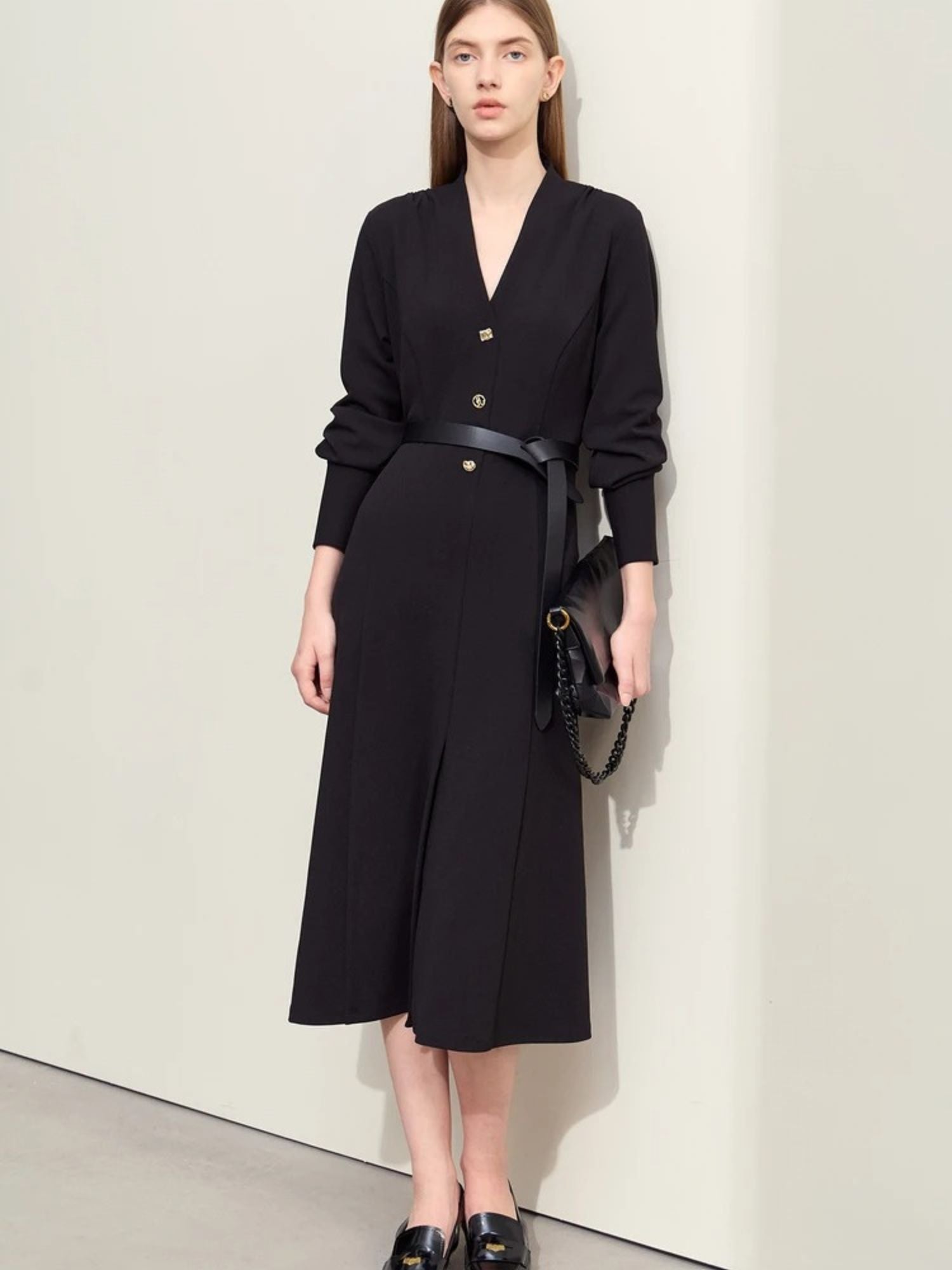 Black long-sleeve midi dress with v-neckline, gold buttons, and belted waist