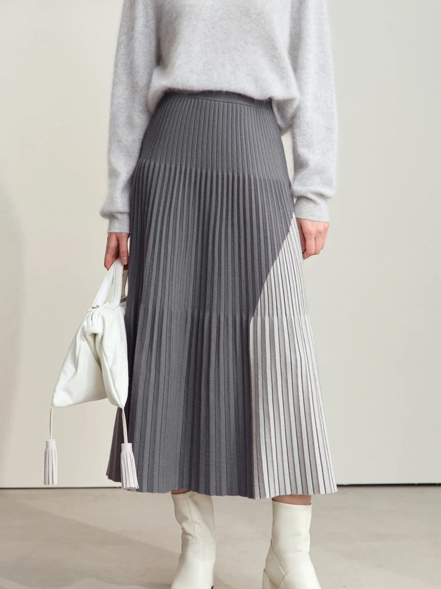 Front view of two-tone pleated skirt with high waist and soft knit texture