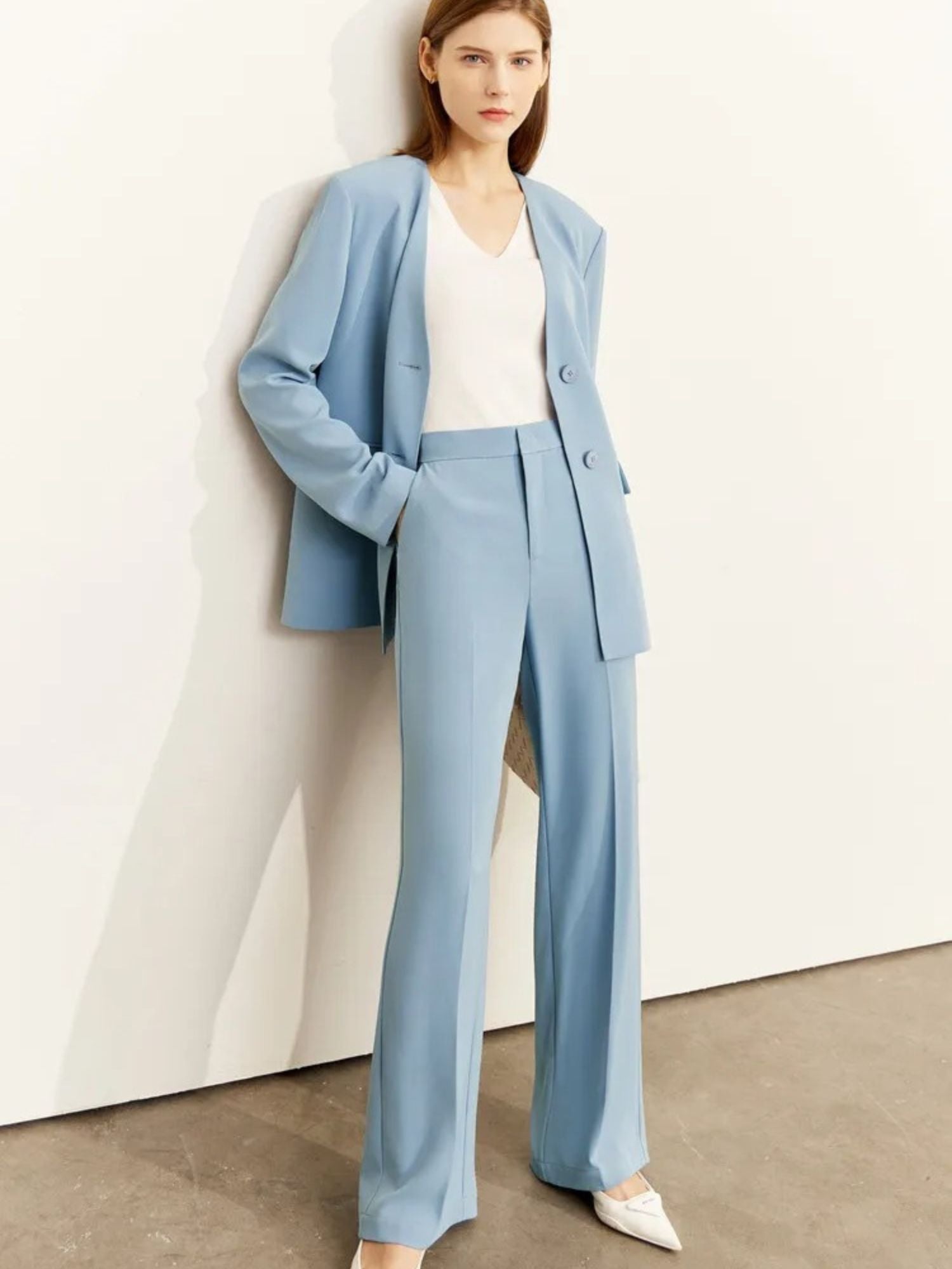 Side profile of light blue pantsuit with notch lapel and soft tailoring