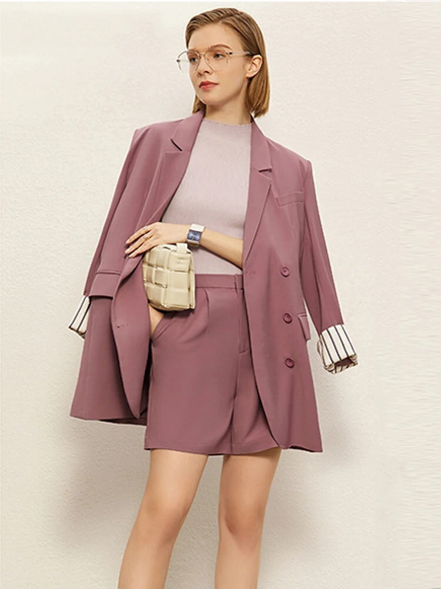 Dusty rose blazer and shorts set, styled with draped shoulders and white inner top