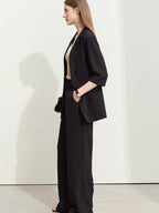 Side profile of oversized black blazer with notch collar and dropped shoulders