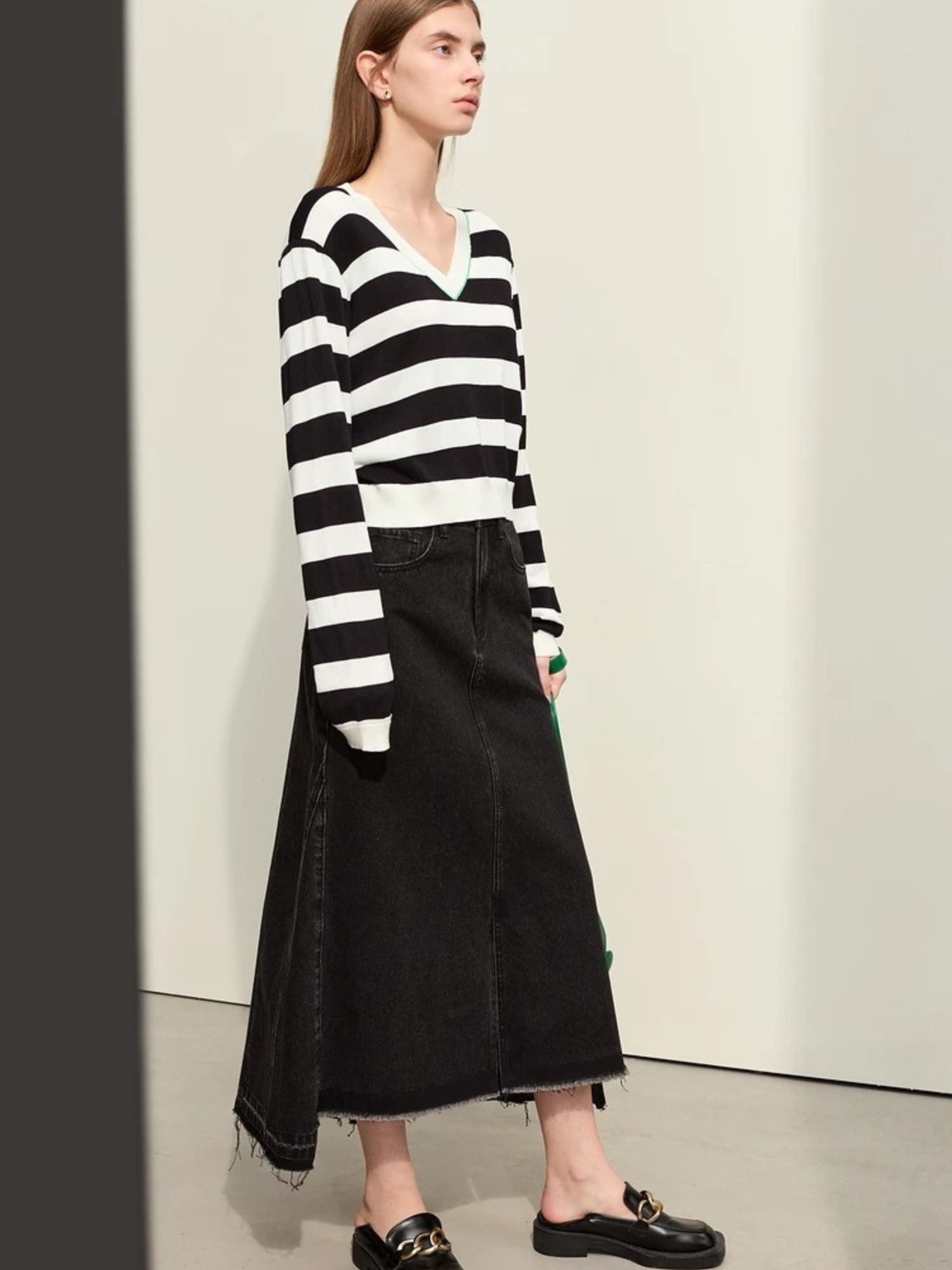 Black pleated midi skirt styled with black and white striped sweater

