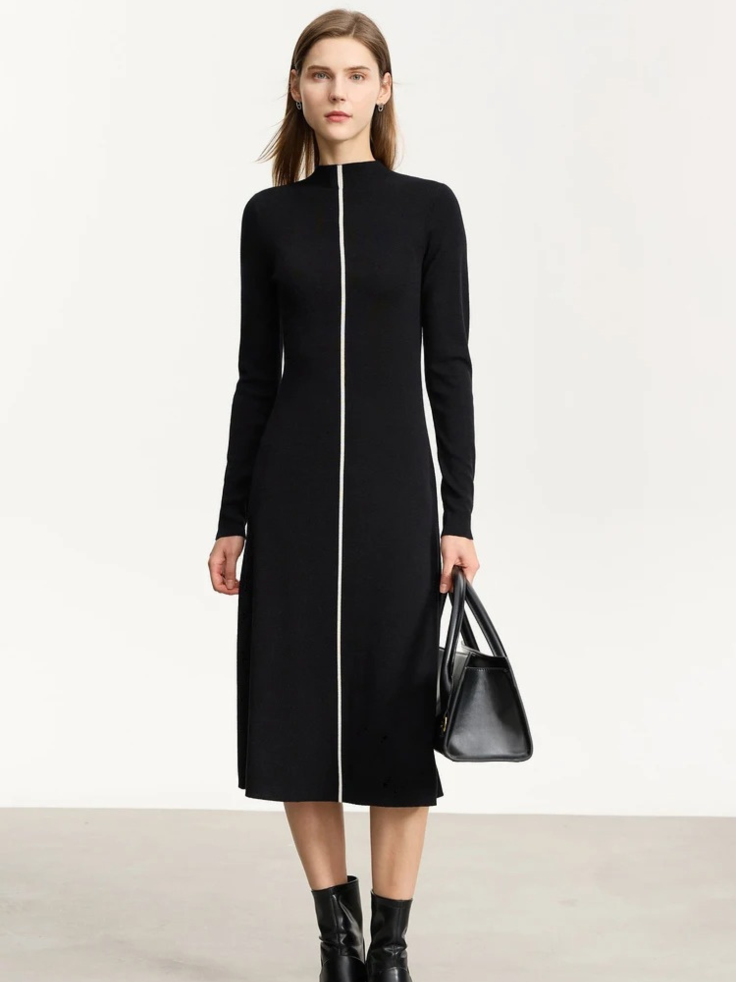 Front view of black zip-front knit dress with long sleeves and structured shape