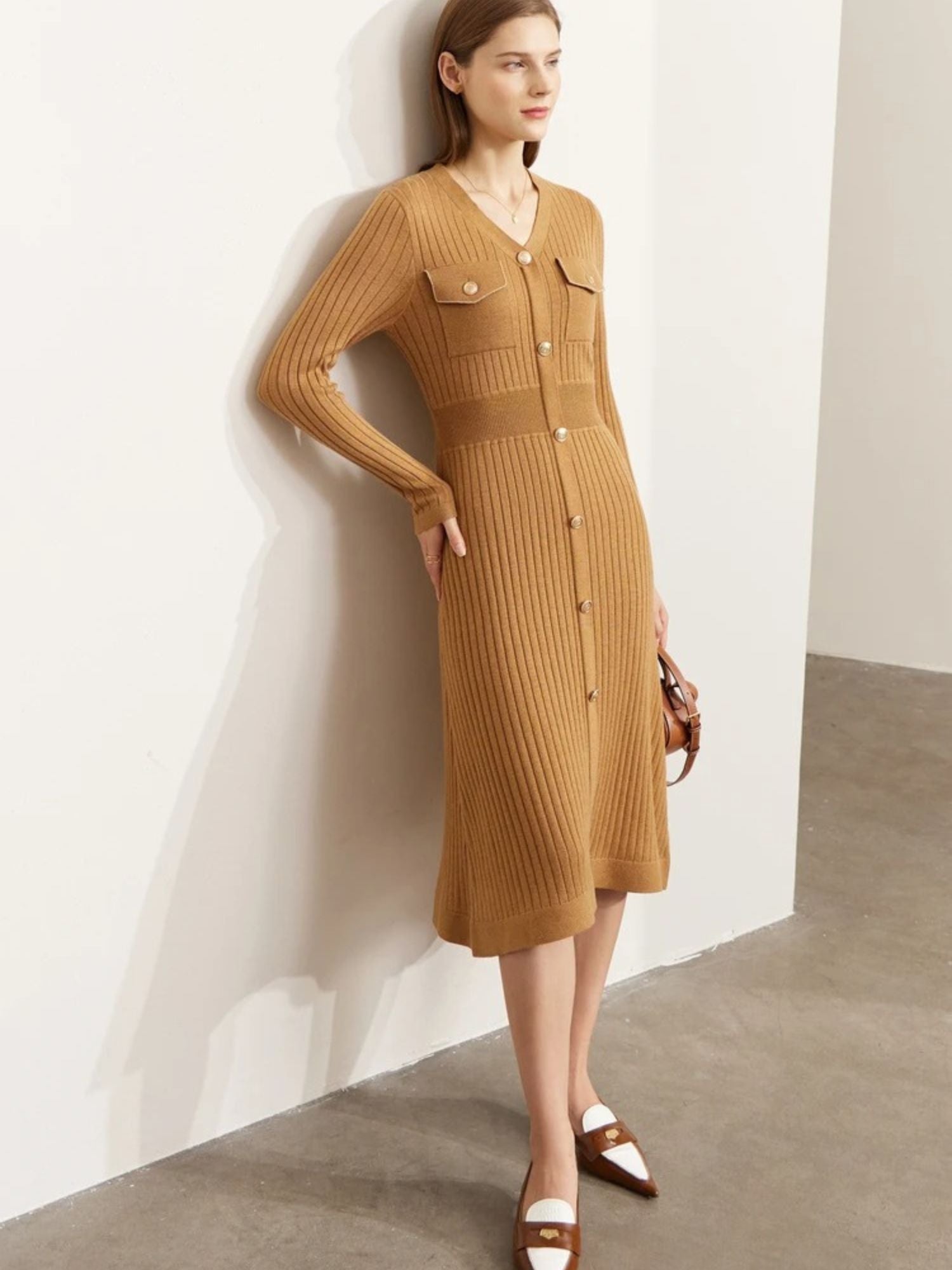 Front view of camel ribbed knit dress with button closure and fitted sleeves