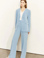 Model in light blue pantsuit with v-neckline blazer and pointed heels