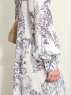 Front view of light floral midi dress with v-neckline and cream heels