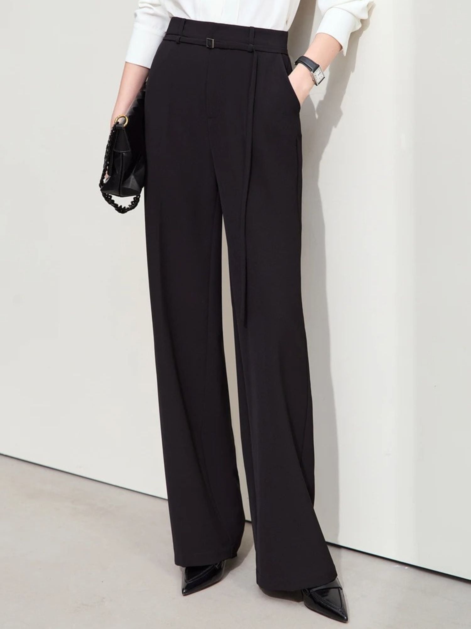 Close-up of black wide-leg trousers with high waist and clean front