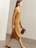 Side view of camel midi dress with gold buttons and soft pleated hem