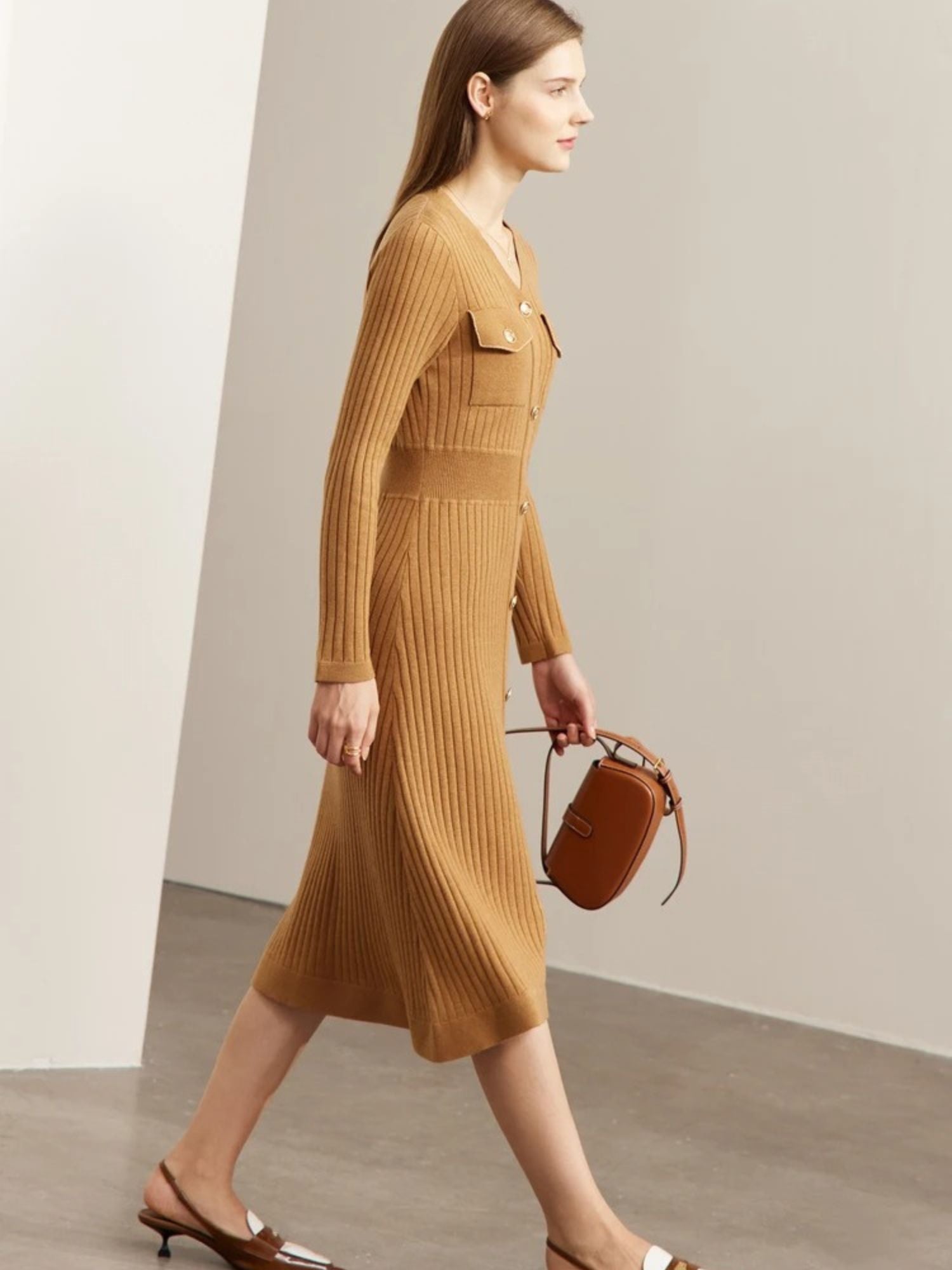Side view of camel midi dress with gold buttons and soft pleated hem