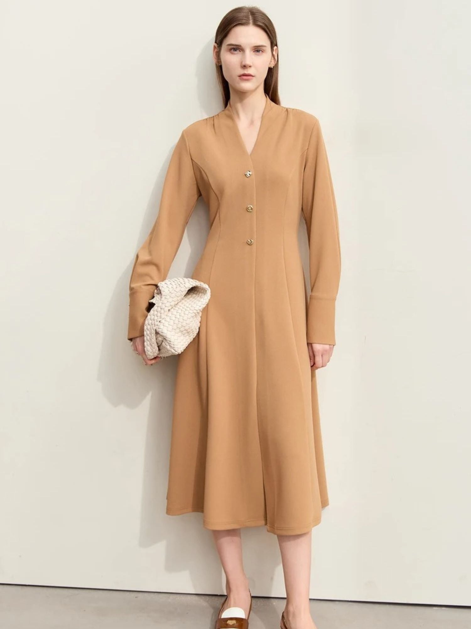 Front view of camel v-neck midi dress with long sleeves and soft pleats