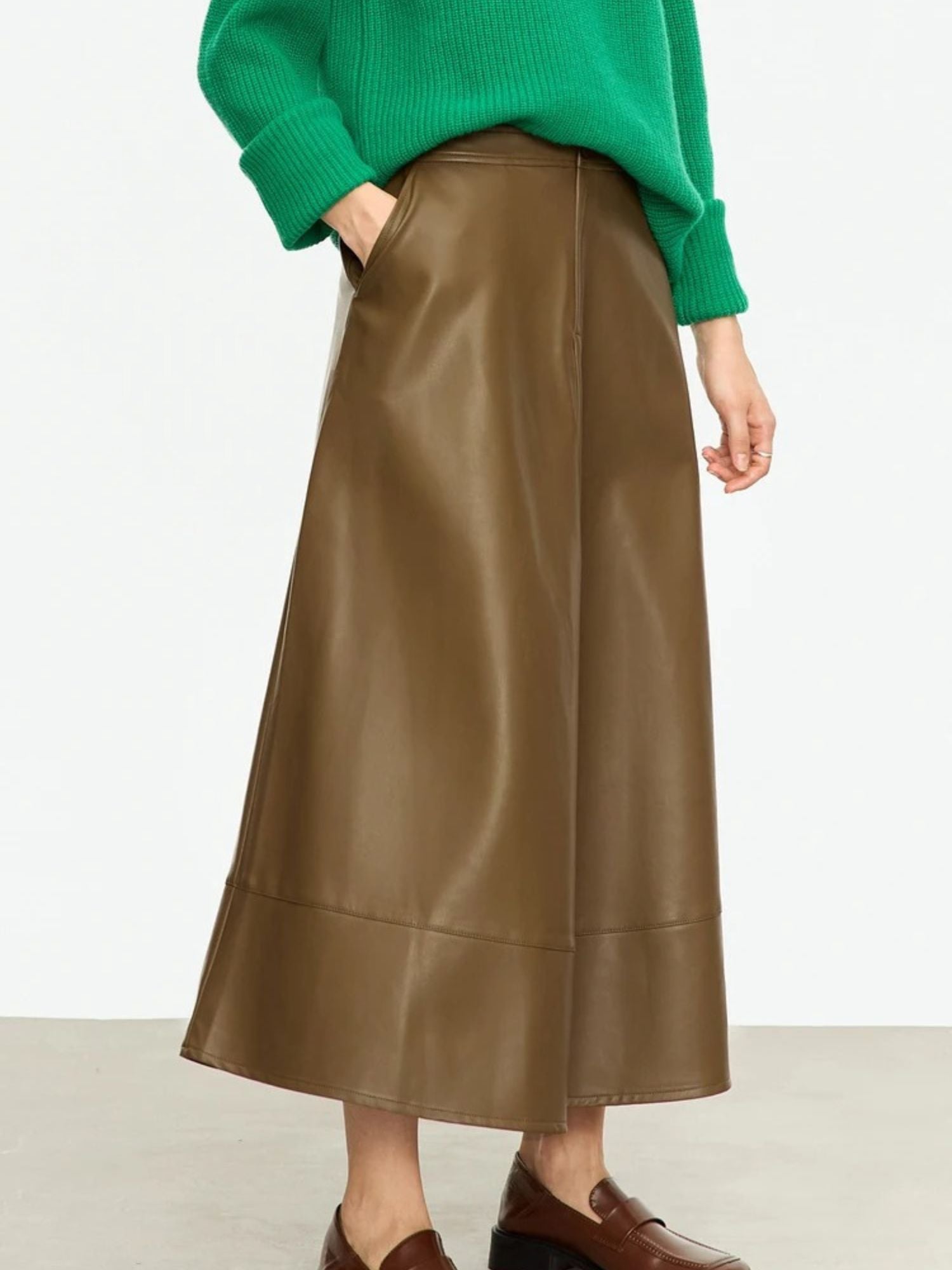 Side profile of brown midi skirt with soft sheen and flared hem