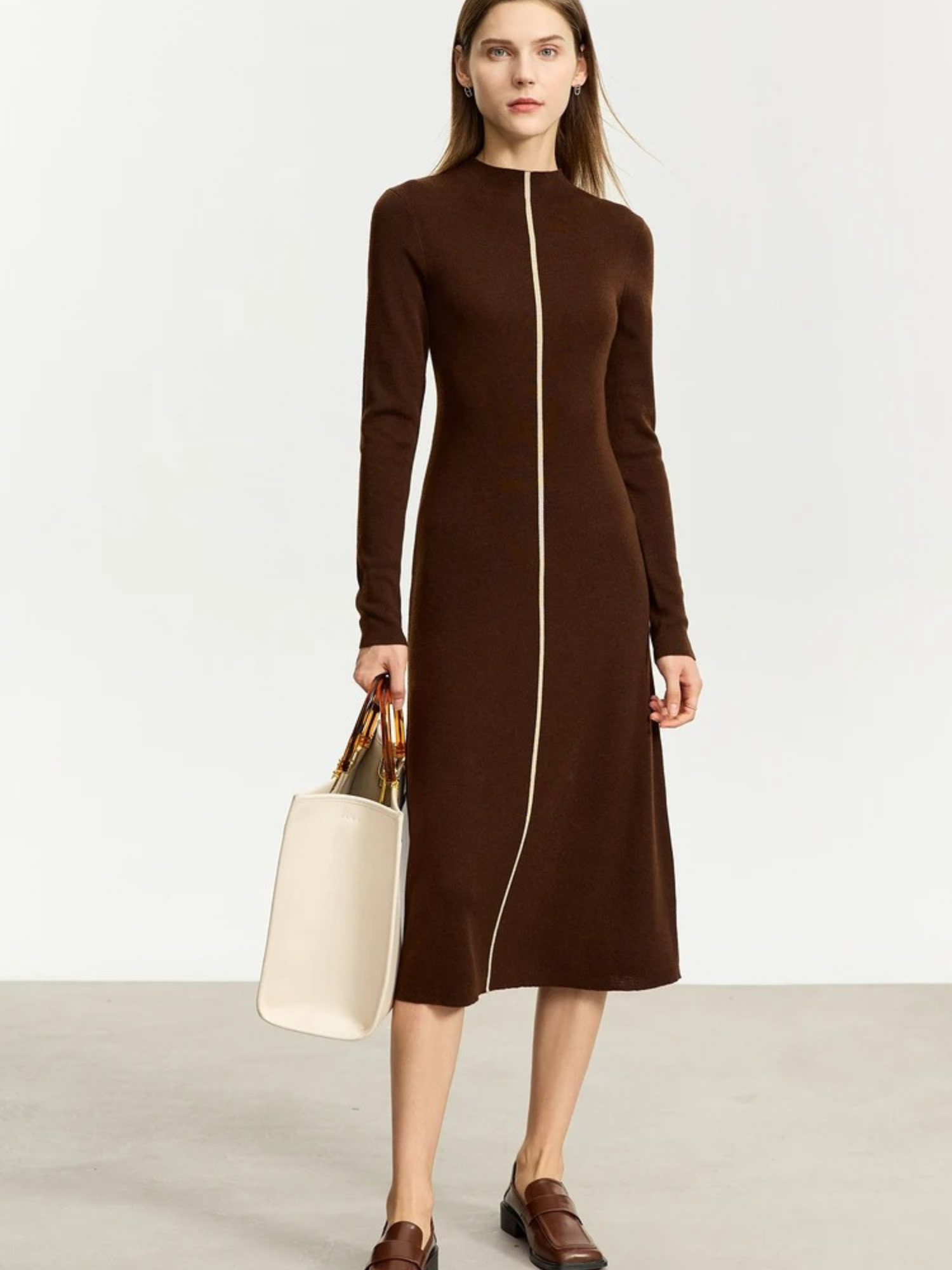 Seated view of brown ribbed knit dress with zipper and folded collar