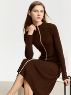Side view of brown zip-front dress in motion, styled with minimal accessories